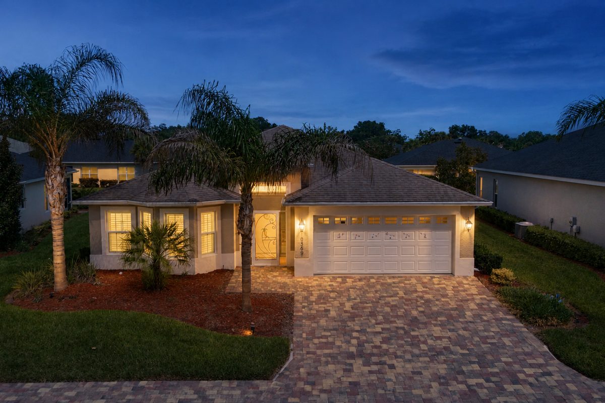 10369 Silver Maple Ave, Oxford FL - twilight front elevation with paver driveway